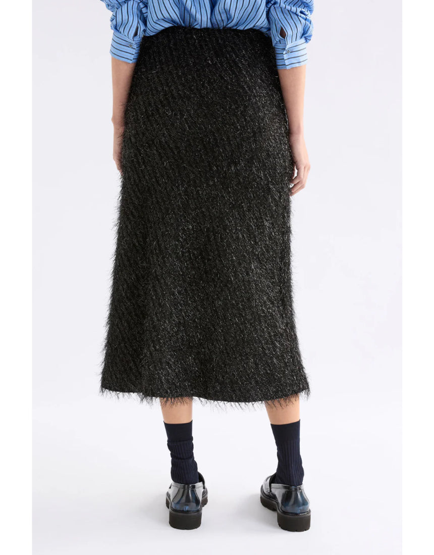 Black Elk Ilta Skirt made of flowing fabric, featuring a stylish design and gathered waistband, perfect for casual or dressy outfits.