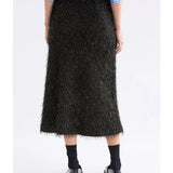 Black Elk Ilta Skirt made of flowing fabric, featuring a stylish design and gathered waistband, perfect for casual or dressy outfits.