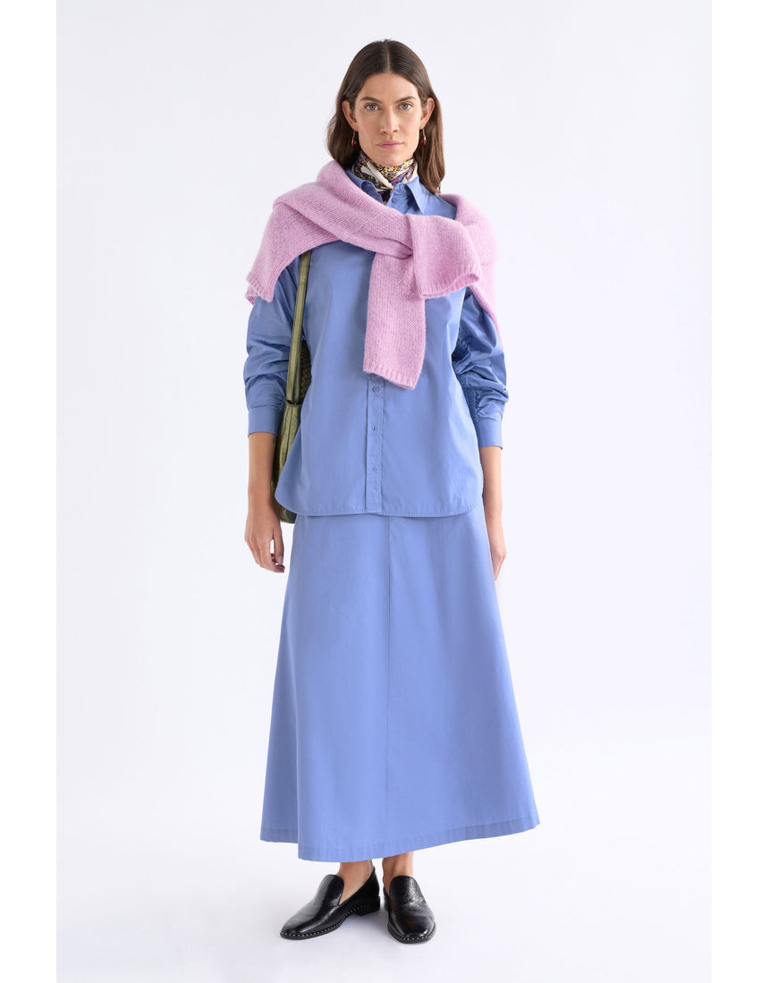 Dusk blue Elk Sol Shirt by ELK The Label, a stylish women's top with a relaxed fit and soft fabric, displayed on a hanger.