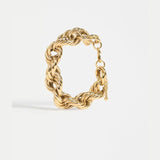 Elk Reppen gold bracelet featuring sleek, minimalist design with smooth metal finish, stylish accessory for everyday wear.