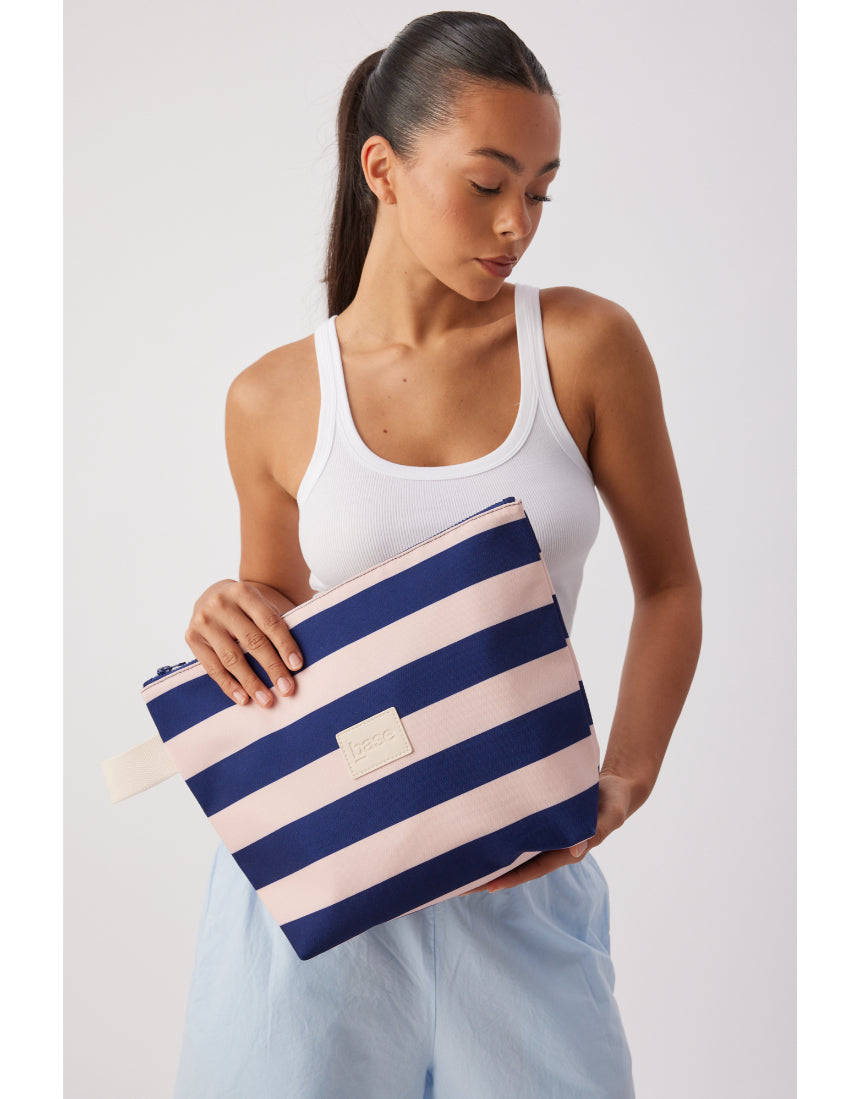 Large Regatta Stripe Wet Base by Base, showcasing a colorful, striped inflatable stand-up paddleboard on water.