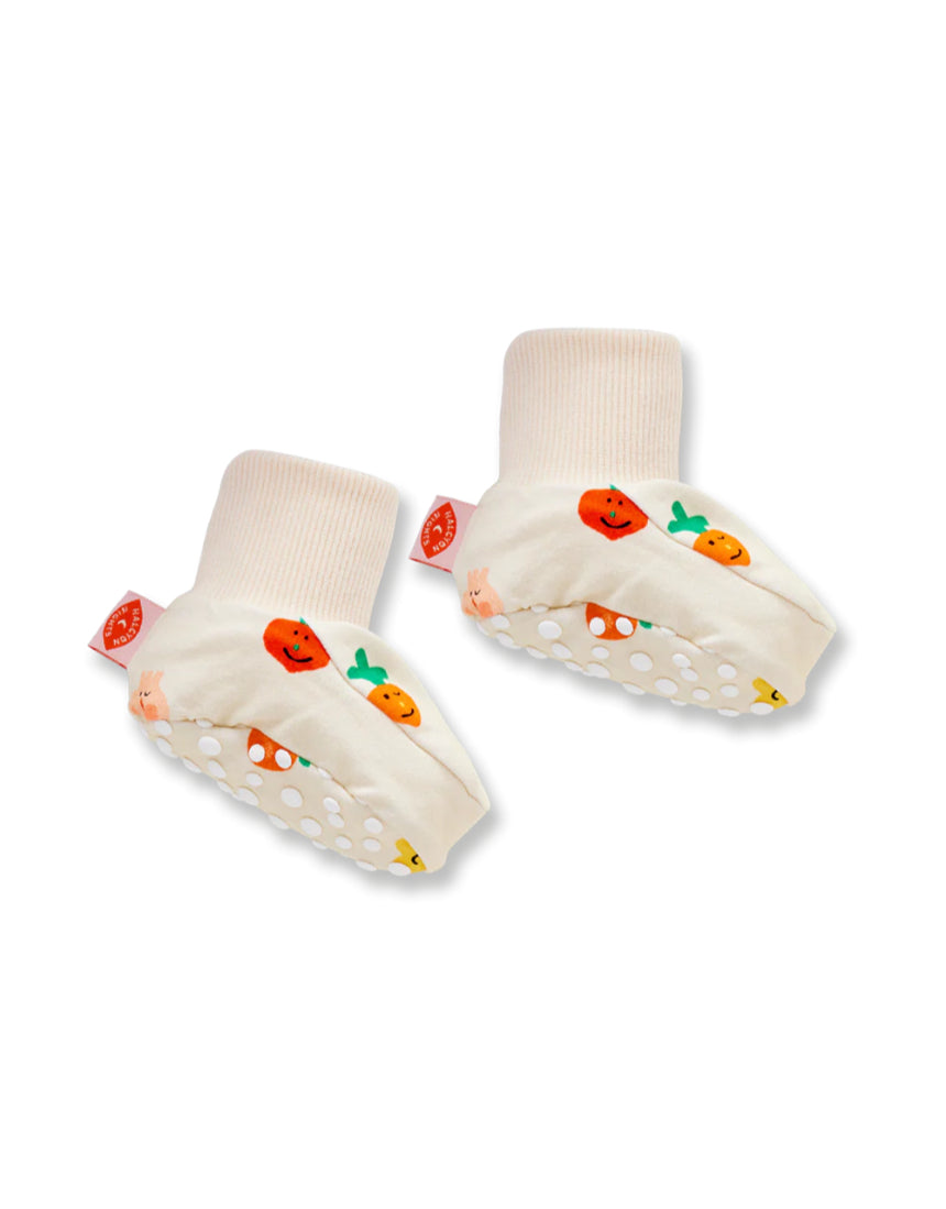 Close-up of Halcyon Nights Teeny Tiny Veg Baby Booties, soft baby clothing footwear with colorful vegetable designs.