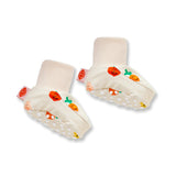 Close-up of Halcyon Nights Teeny Tiny Veg Baby Booties, soft baby clothing footwear with colorful vegetable designs.