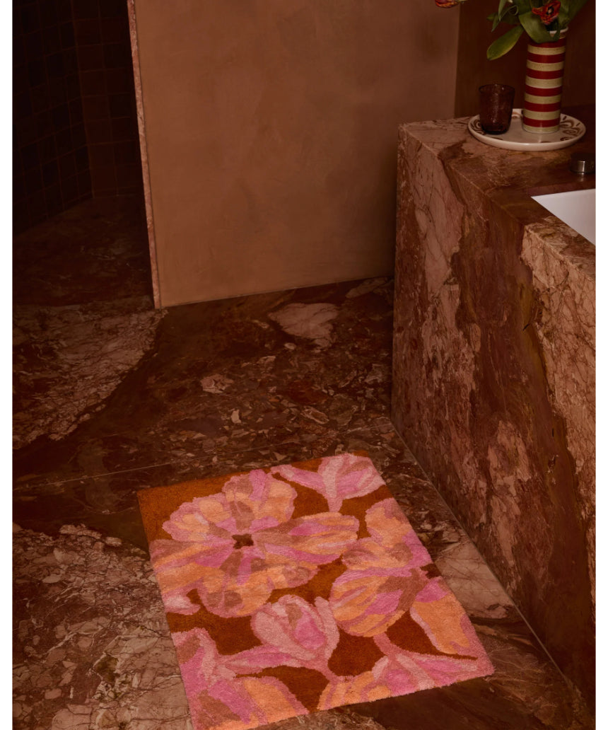 Pink Dutch floral bath mat by Bonnie and Neil with a soft, textured surface, perfect for bathroom decor.