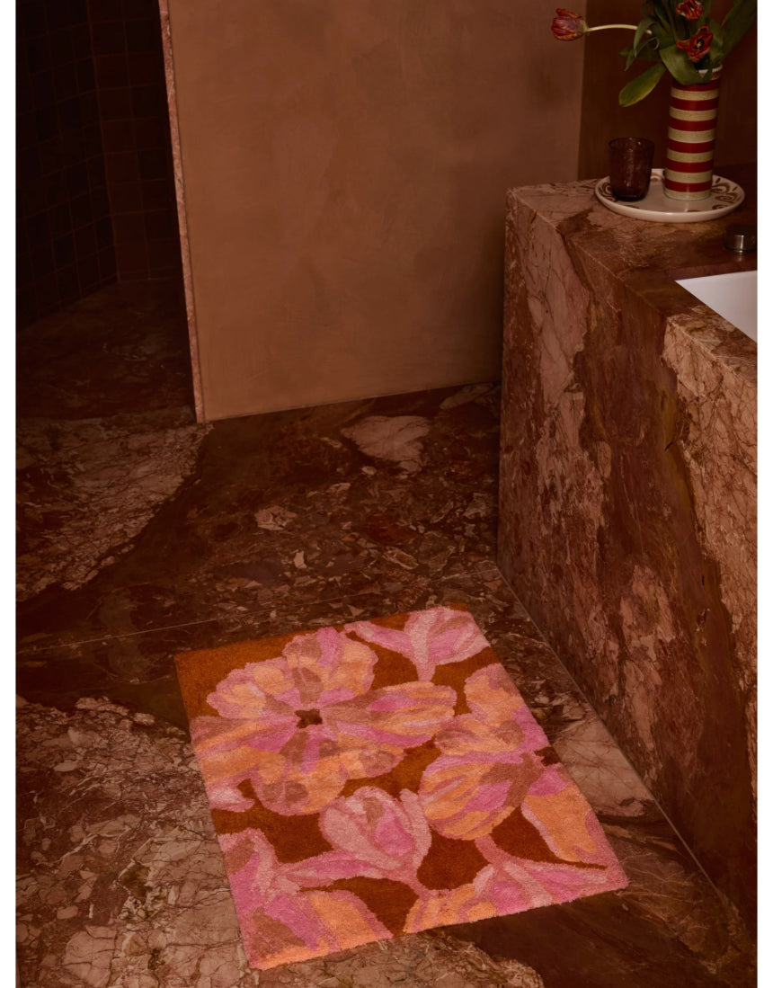 Pink Dutch floral bath mat by Bonnie and Neil with a soft, textured surface, perfect for bathroom decor.