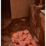 Pink Dutch floral bath mat by Bonnie and Neil with a soft, textured surface, perfect for bathroom decor.