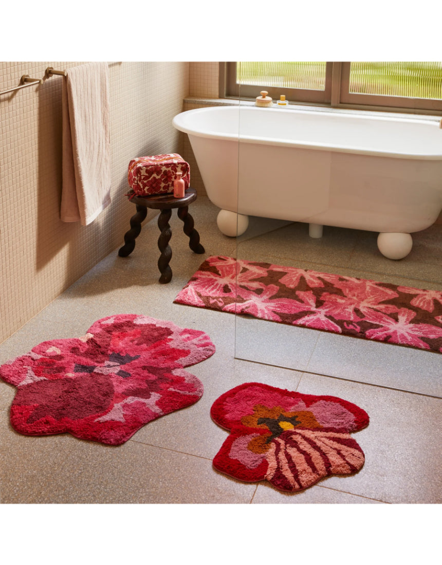 Pink cotton bath mat from Bonnie and Neil, long and plush, designed for bathroom decor and comfort.