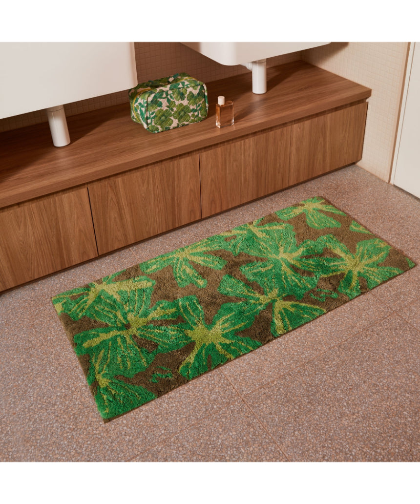 Bonnie and Neil Mave Khaki cotton bath mat with textured design, shown in a bathroom setting.