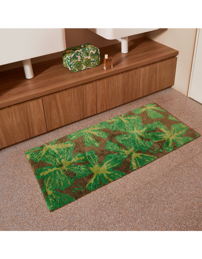 Bonnie and Neil Mave Khaki cotton bath mat with textured design, shown in a bathroom setting.