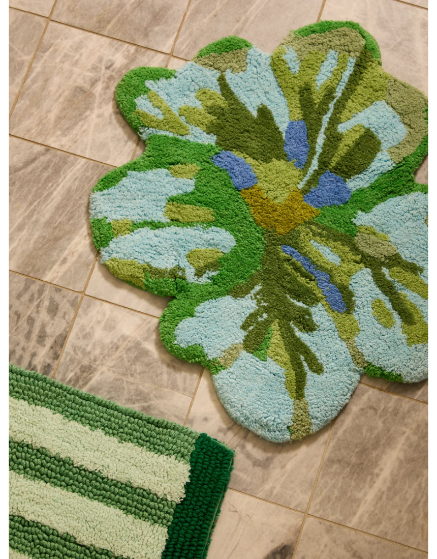 Bonnie and Neil Mini Tulip Blue Green Bath Mat with floral design, soft cotton material, placed in a stylish bathroom setting.