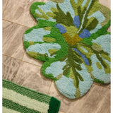 Bonnie and Neil Mini Tulip Blue Green Bath Mat with floral design, soft cotton material, placed in a stylish bathroom setting.
