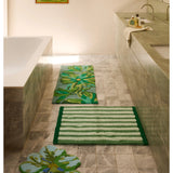 Reversible green striped bath mat by Bonnie and Neil, styled in a bathroom setting with soft textures and modern design.