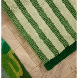 Reversible green stripe bath mat by Bonnie and Neil, featuring bold stripes and soft, absorbent fabric for bathroom decor.