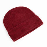 Maison Fanli Auguste Beanie in Bordeaux color, soft knit fabric, shown on a head, stylish winter accessory.