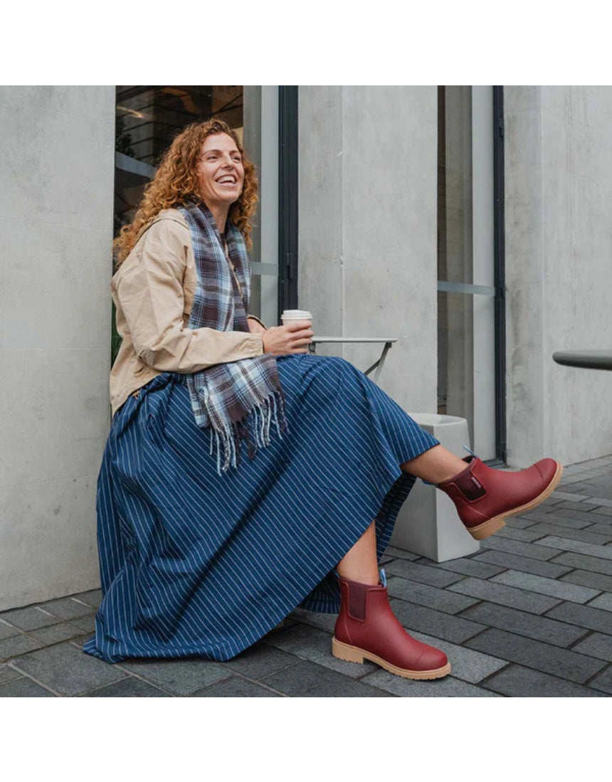 Merry People Bobbi gumboots in brick red, stylish waterproof footwear with a sleek design, perfect for rainy weather.