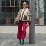 Teal Merry People Bobbi gumboots displayed outdoors, featuring waterproof rubber material and stylish design for rainy days.