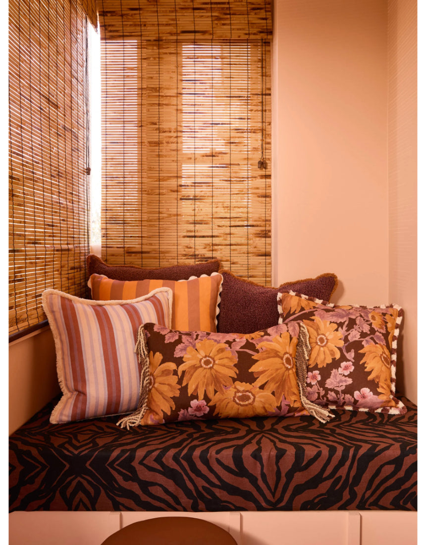 Bonnie and Neil marigold amber linen cushion, 50cm, styled for living room decor with vibrant floral pattern.