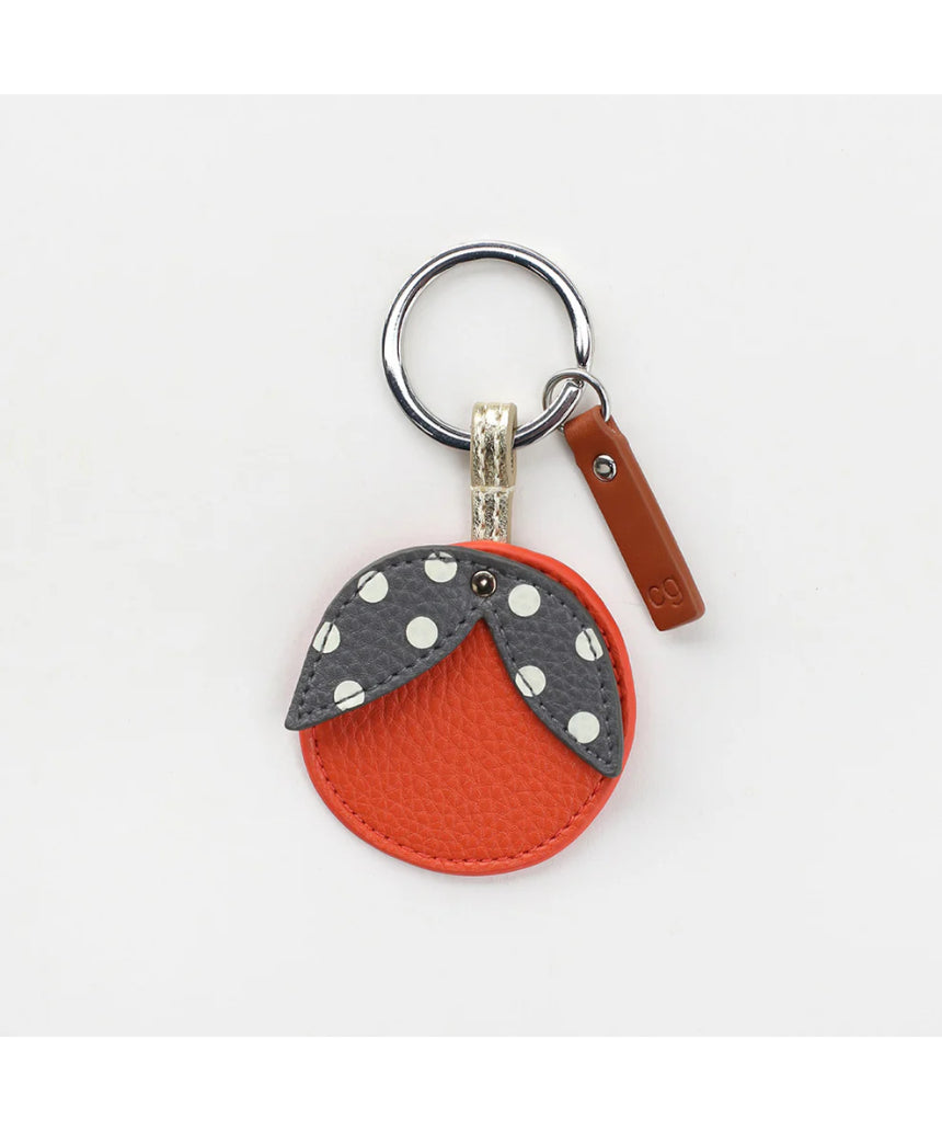 Orange key ring from Scarpa Imports with a circular design and metal keyring attachment.