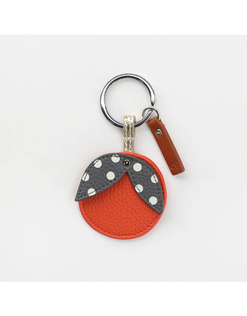 Orange key ring from Scarpa Imports with a circular design and metal keyring attachment.