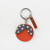 Orange key ring from Scarpa Imports with a circular design and metal keyring attachment.