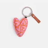 Pink heart-pattern key ring from Scarpa Imports with a decorative pink and white design, ideal for holding keys or as a accessory.