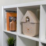 Beige Fisura cuckoo clock with traditional design and wooden details, showcasing the clock face and decorative elements.