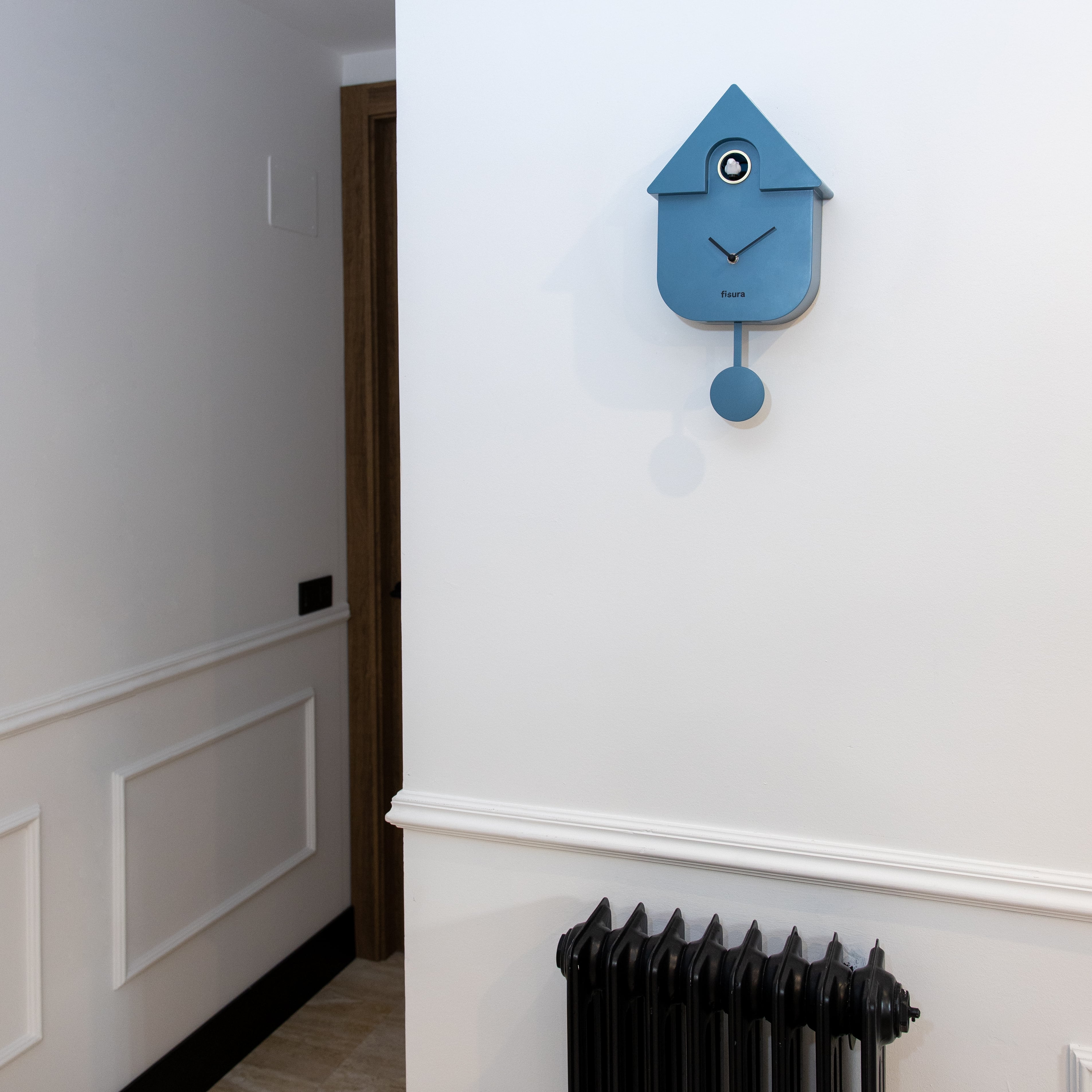 Blue Fisura cuckoo clock with a wooden case and traditional design, featuring a small cuckoo bird and clock face.