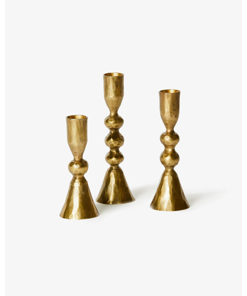 Set of three brass candle holders from Bonnie and Neil, featuring modern and stylish designs for decorative use.