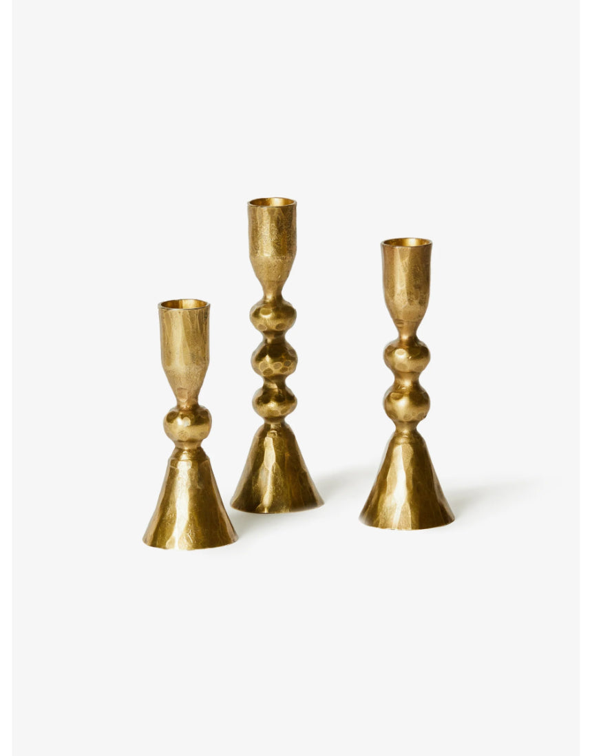Set of three brass candle holders from Bonnie and Neil, featuring modern and stylish designs for decorative use.