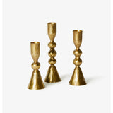 Set of three brass candle holders from Bonnie and Neil, featuring modern and stylish designs for decorative use.
