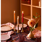 Set of three brass candle holders by Bonnie and Neil, decorative vintage-style holders with intricate design details.
