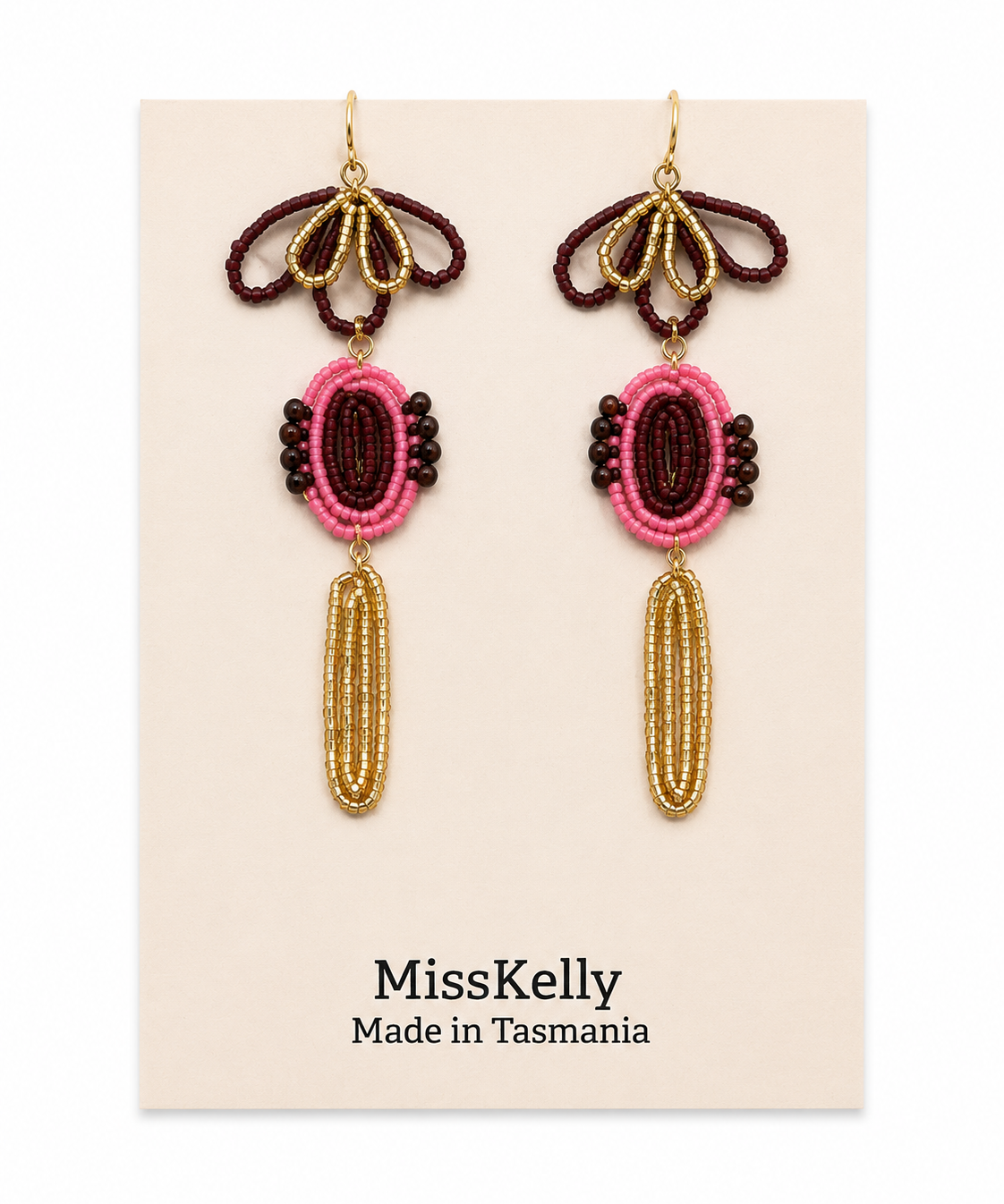 Miss Kelly Madison statement earrings featuring bold, geometric gold-tone design on a white background.