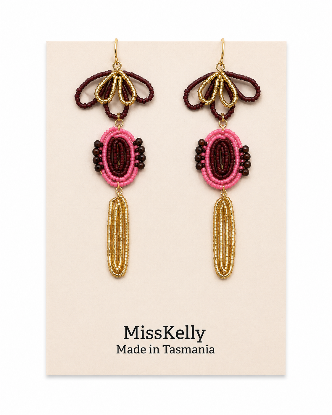 Miss Kelly Madison statement earrings featuring bold, geometric gold-tone design on a white background.