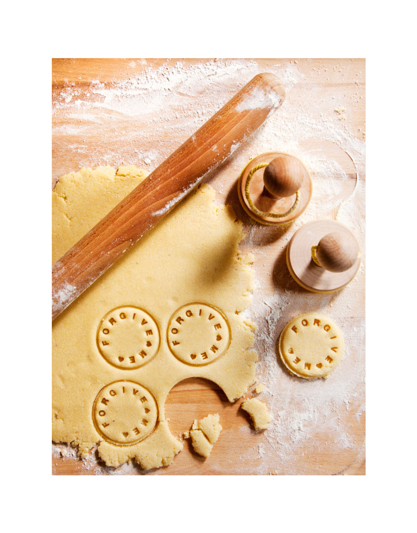 Suck UK customizable cookie stamp with engraved design, showing the stamp pressed onto freshly baked cookies.