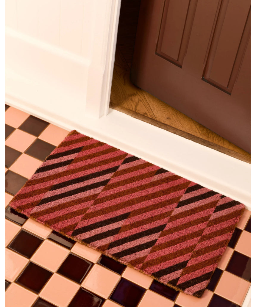 Pink patchwork door mat by Bonnie and Neil with floral and geometric patterns, ideal for welcoming entryways.
