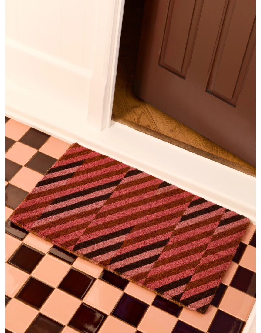 Pink patchwork door mat by Bonnie and Neil with floral and geometric patterns, ideal for welcoming entryways.