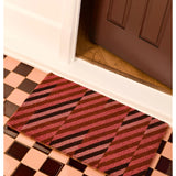 Pink patchwork door mat by Bonnie and Neil with floral and geometric patterns, ideal for welcoming entryways.