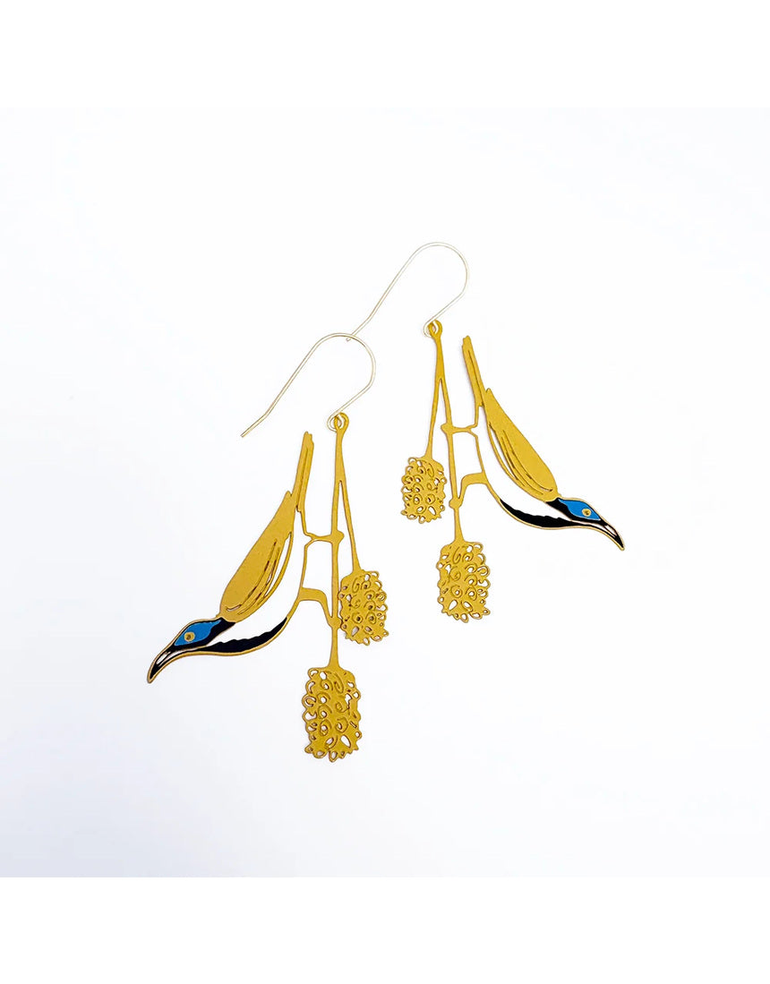 Denz Blue Faced Honeyeater earrings with honey, blue, and black feathers and metal hooks, showcasing vibrant, nature-inspired jewelry.