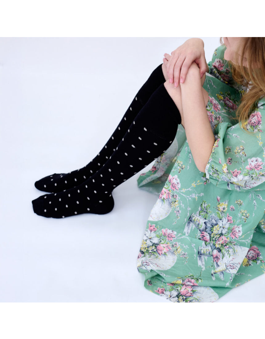 Black Dotty Merino Wool Socks by Tightology, close-up of cozy, patterned wool socks with small dot designs.