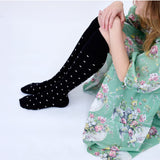 Black Dotty Merino Wool Socks by Tightology, close-up of cozy, patterned wool socks with small dot designs.