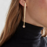 Elk Kyna gold earrings with sleek, minimalist design featuring smooth, shiny gold hoops for elegant everyday wear.