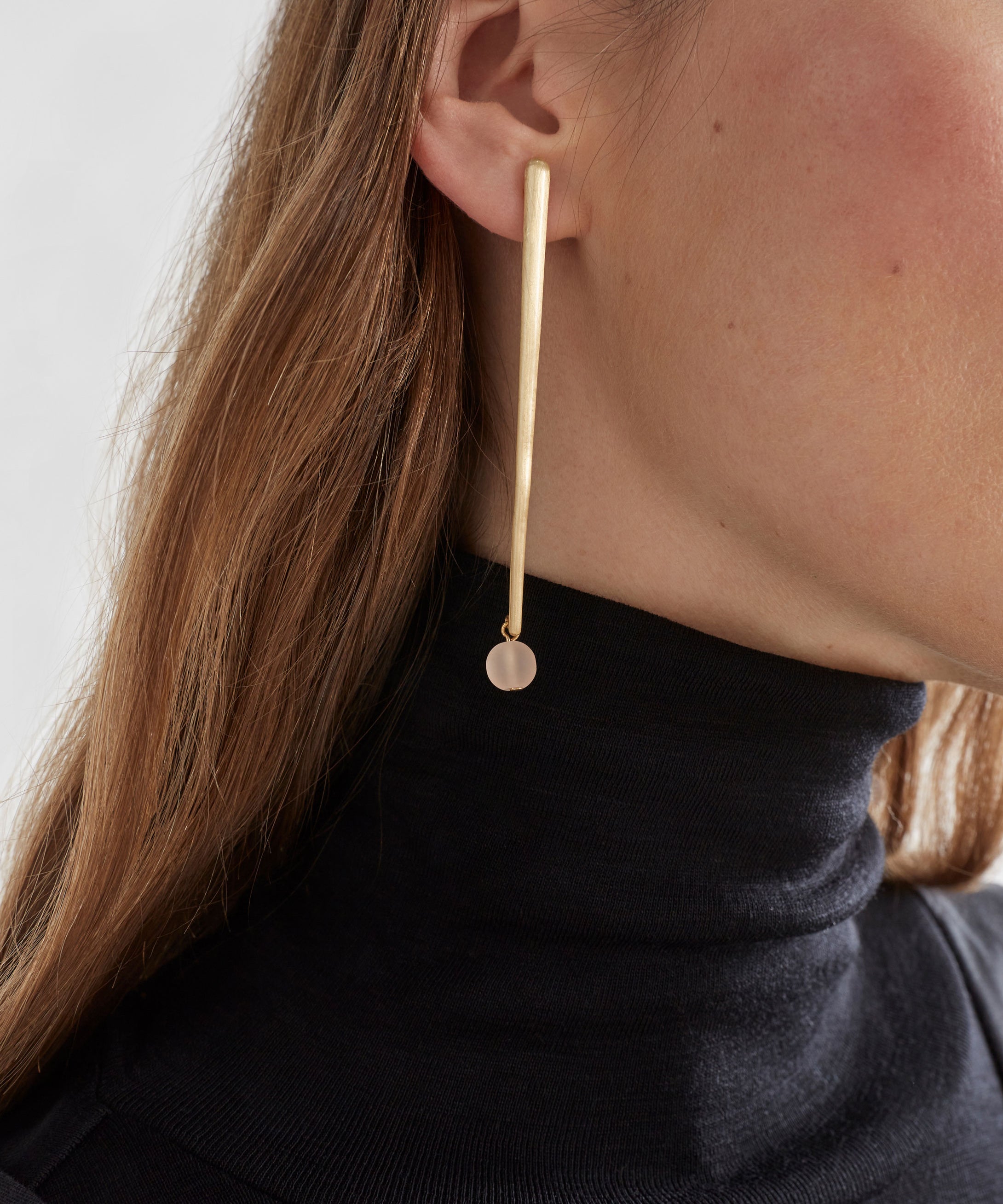 Elk Kyna gold earrings with sleek, minimalist design featuring smooth, shiny gold hoops for elegant everyday wear.