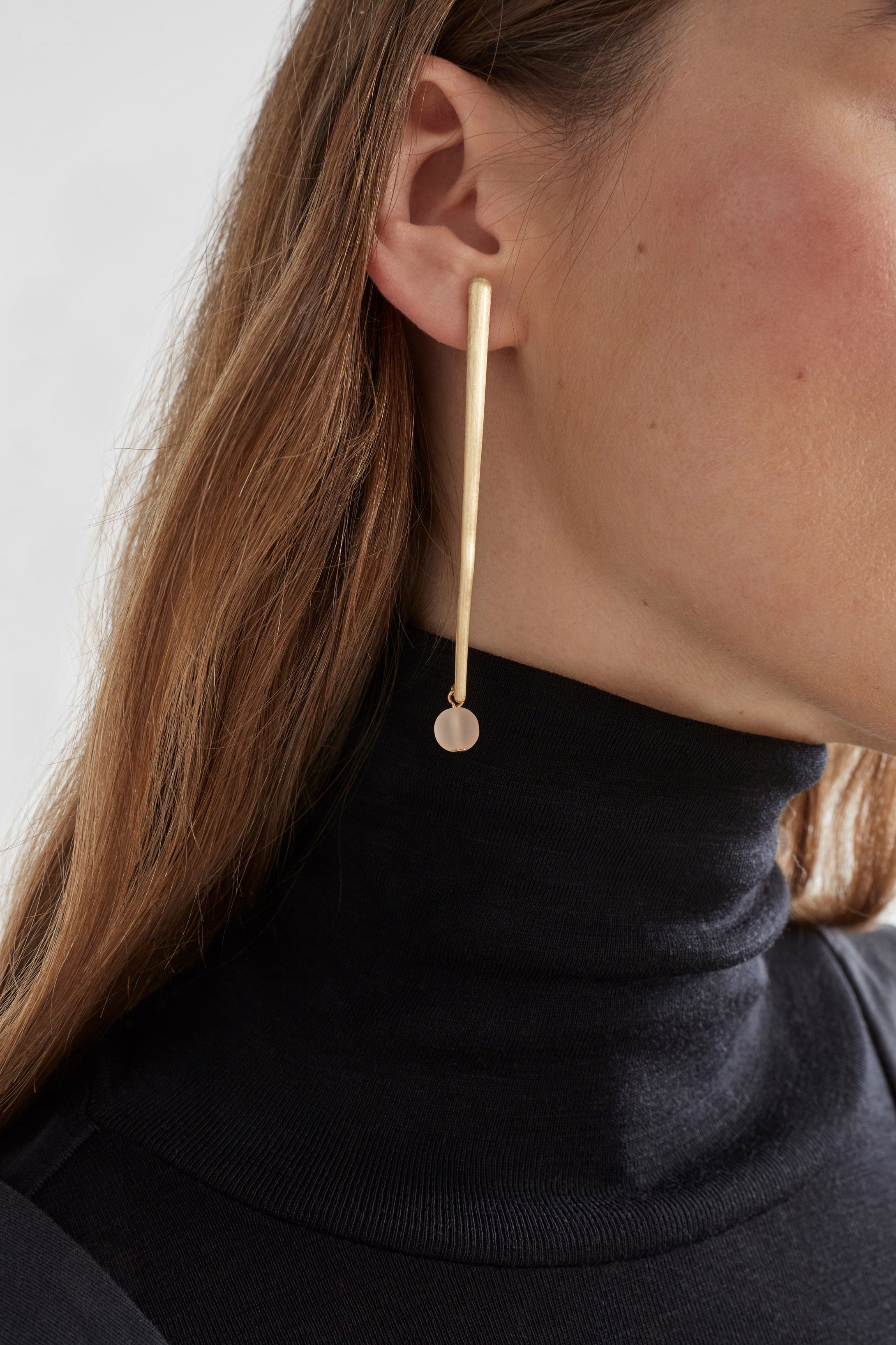 Elk Kyna gold earrings with sleek, minimalist design featuring smooth, shiny gold hoops for elegant everyday wear.