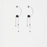 Elk Pykka Drop Earring in gunmetal with sleek, modern design and teardrop shape, hanging elegantly from the ear.