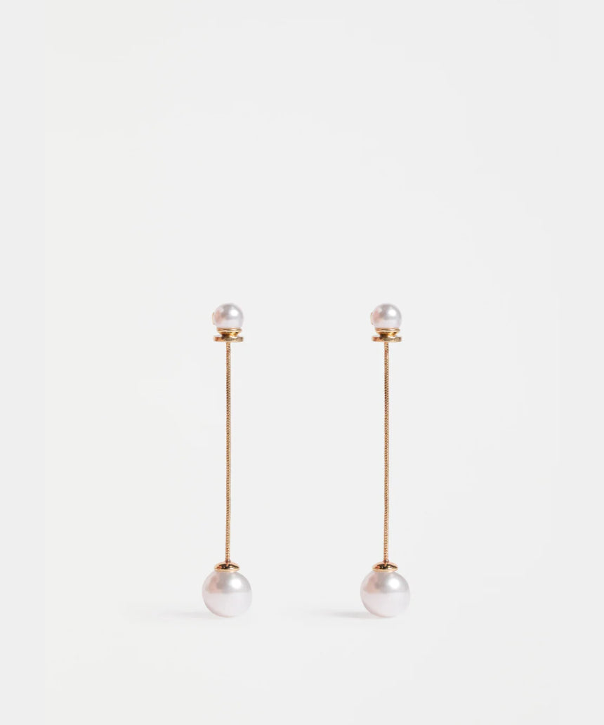 Gold Elk Sarra Drop Earring featuring a sleek, curved design with a polished finish, hanging elegantly against a plain background.