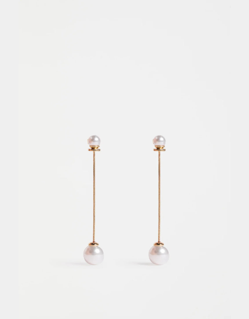 Gold Elk Sarra Drop Earring featuring a sleek, curved design with a polished finish, hanging elegantly against a plain background.