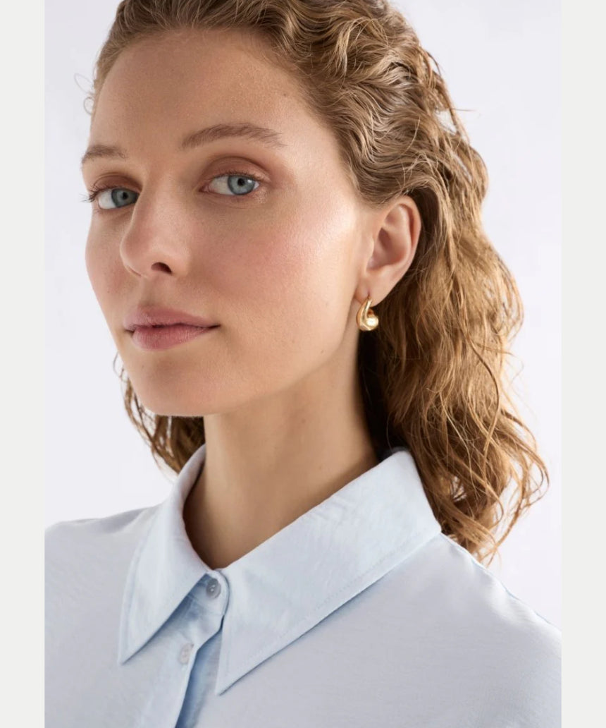 Gold Elk Aisem Mini Hoop Earring with a sleek, minimalist design, shown close-up on a white background.