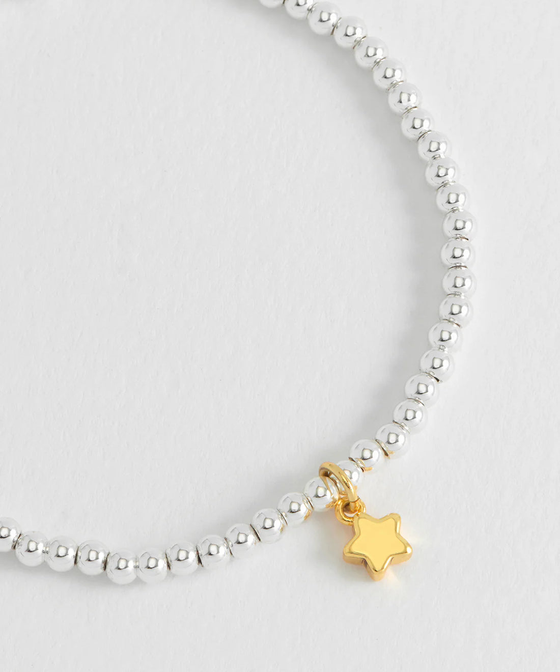 Estella Bartlett Puffed Star Sienna bracelet featuring a star-shaped charm on a gold-tone bracelet.