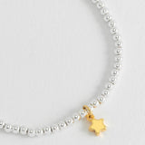 Estella Bartlett Puffed Star Sienna bracelet featuring a star-shaped charm on a gold-tone bracelet.