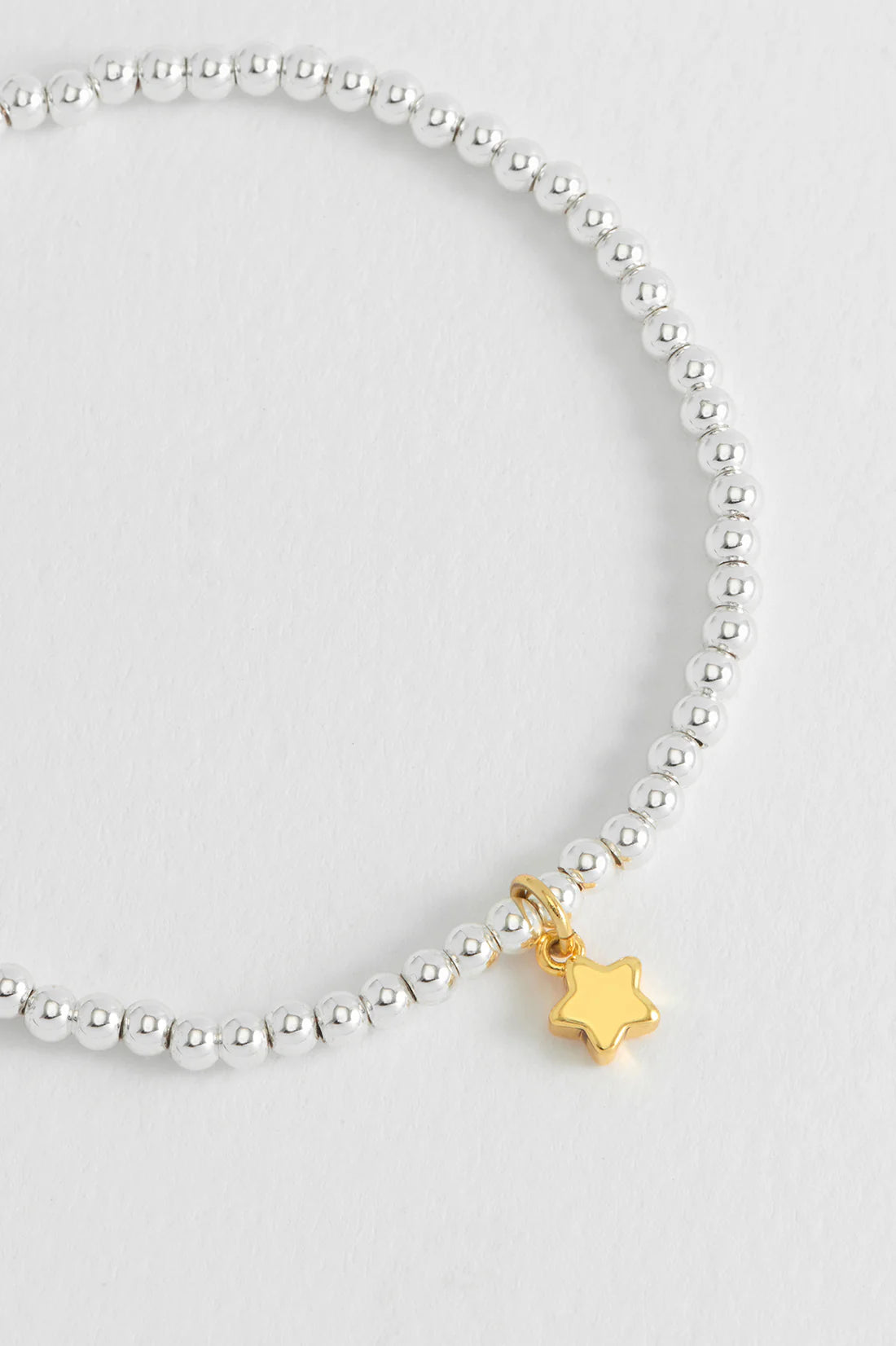 Estella Bartlett Puffed Star Sienna bracelet featuring a star-shaped charm on a gold-tone bracelet.